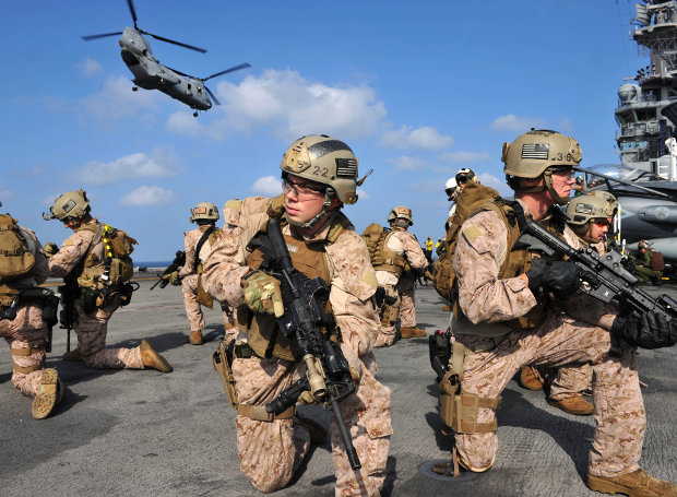 120112-N-KD852-138 ARABIAN SEA (Jan. 12, 2012) Marines assigned to the 11th Marine Expeditionary Unit position themselves on the flight deck after fast roping out of a CH-46E Sea Knight aboard the amphibious assault ship USS Makin Island (LHD 8). Makin Island with embarked Marines assigned to the 11th Marine Expeditionary Unit (MEU) are deployed supporting maritime security operations and theater security cooperation efforts in the U.S. 5th Fleet area of responsibility. (U.S. Navy photo by Chief Mass Communication Specialist John Lill /Released)