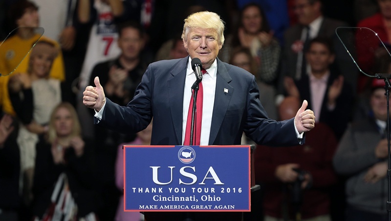 epa05655888 US President-elect Donald Trump speaks during the first stop of his 'USA Thank You Tour 2016' rally at US Bank Arena in Cincinnati, Ohio, USA, 01 December 2016.  EPA/MARK LYONS