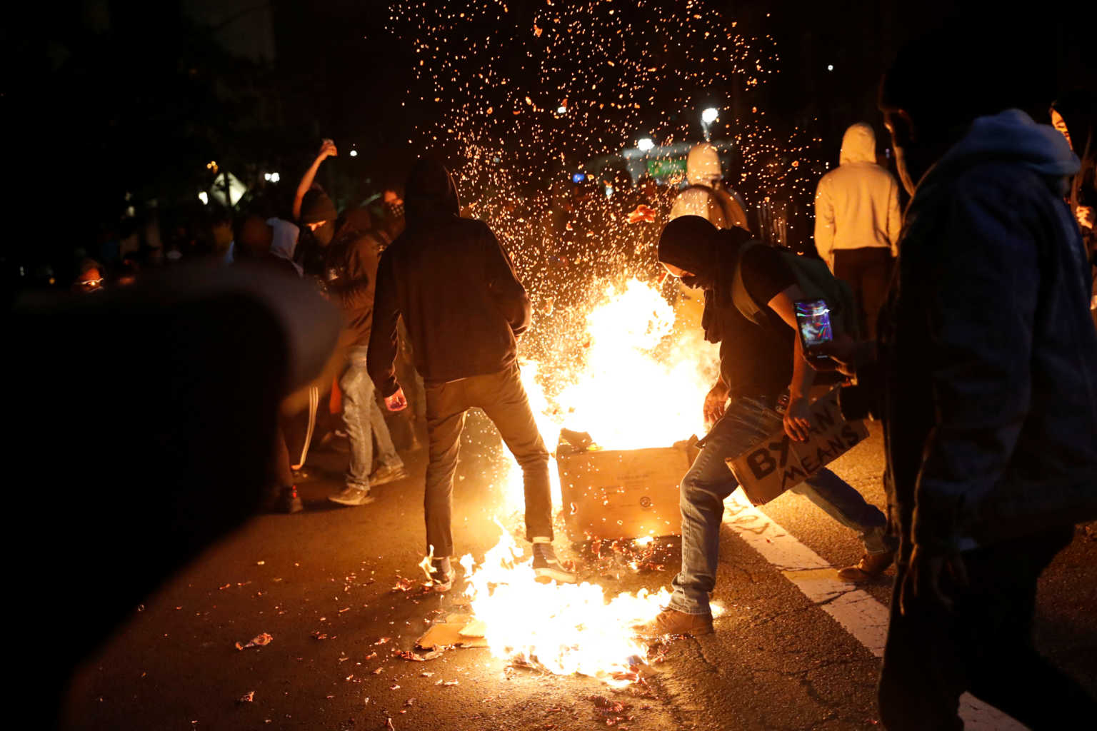 Demonstrators attempt to extinguish a trash fire during a protest against the death of African-American man George Floyd under Minneapolis police custody, in Oakland, California, U.S. May 29, 2020. REUTERS/Stephen Lam