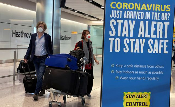 Passengers arrive at Heathrow Airport, as Britain launches its 14-day quarantine for international arrivals, following the outbreak of the coronavirus disease (COVID-19), London, Britain, June 8, 2020. REUTERS/Toby Melville