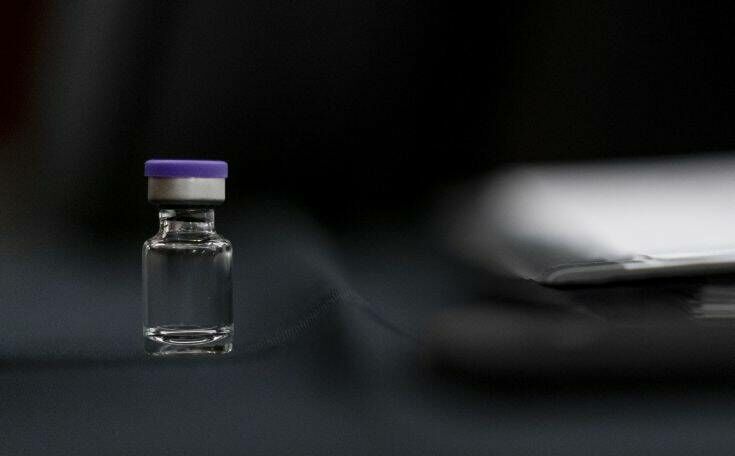 An example of the Pfizer COVID-19 vaccine vial is visible on a desk before a Senate Transportation subcommittee hybrid hearing on transporting ​a coronavirus vaccine on Capitol Hill, Thursday, Dec. 10, 2020, in Washington. (AP Photo/Andrew Harnik, Pool)