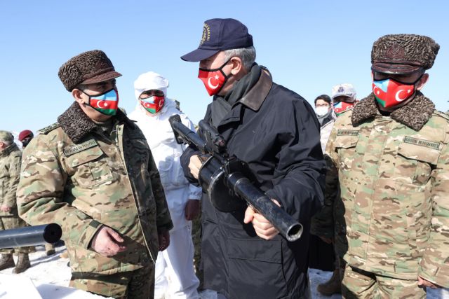 Turkish Defense Minister Hulusi Akar and his Azeri counterpart Zakir Hasanov inspect troops during Turkish-Azeri joint military exercises in the eastern Kars province, Turkey February 11, 2021. Arif Akdogan/Turkish Defense Ministry/Handout via REUTERS ATTENTION EDITORS - THIS PICTURE WAS PROVIDED BY A THIRD PARTY. NO RESALES. NO ARCHIVE.