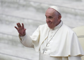 Pope Francis waves as he arrives for an audience with members of St. Pietro and Paolo association, in the Paul VI Hall at the Vatican, Saturday, Jan. 8, 2022. (AP Photo/Alessandra Tarantino)
