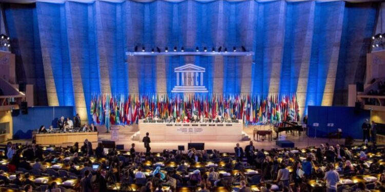 FILE- This Tuesday, Nov. 5, 2013, file photo shows a general view of the UNESCO prior to the opening of General Conference in Paris, France. American influence in culture, science and education around the world will take a high-profile blow on Friday as the US is stripped of its vote at the world's premier cultural agency, UNESCO. The U.S. loses its vote at the Paris-based U.N. Educational, Scientific and Cultural Organization following Washington's decision in 2011 to cut all funding to the U.N. agency over the vote giving Palestine member-state status. (AP Photo/Benjamin Girette, file)