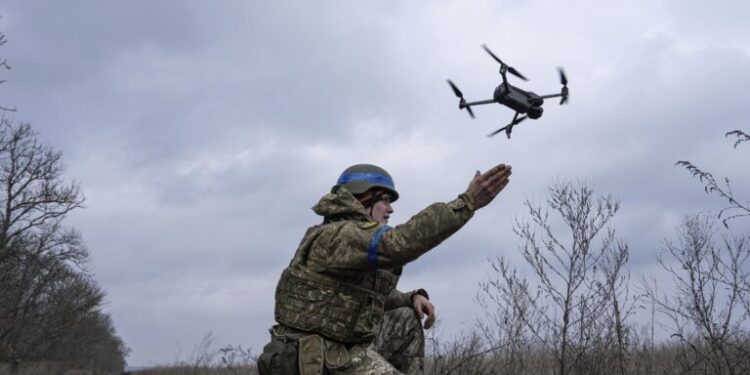 A Ukrainian serviceman of the 68 Oleksa Dovbush hunting brigade, launches a drone at the frontline near Vuhledar, Ukraine, Wednesday, Feb. 22, 2023. (AP Photo/Evgeniy Maloletka)