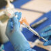 FILE - A nurse prepares a syringe of a COVID-19 vaccine at an inoculation station in Jackson, Miss., Tuesday, July 19, 2022. On Thursday, Oct. 20, 2022, a panel of U.S. vaccine experts said COVID-19 shots should be added to the lists of recommended vaccinations for kids and adults. (AP Photo/Rogelio V. Solis, File)