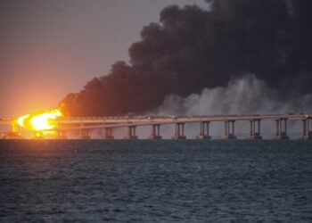 FILE - Flame and smoke rise fron Crimean Bridge connecting Russian mainland and Crimean peninsula over the Kerch Strait, in Kerch, Crimea, Saturday, Oct. 8, 2022. The Crimean Peninsula's balmy beaches have been vacation spots for Russian czars and has hosted history-shaking meetings of world leaders. And it has been the site of ethnic persecutions, forced deportations and political repression. Now, as Russia’s war in Ukraine enters its 18th month, the Black Sea peninsula is again both a playground and a battleground. (AP Photo, File)