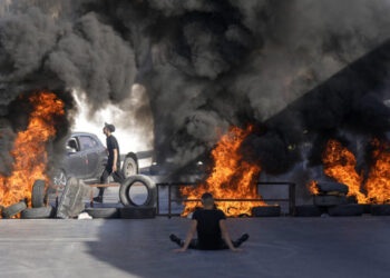 Tires set fire by Palestinians burn at the site where two Palestinians were shot and killed by the Israeli army in the Jalazone refugee camp near the city of Ramallah, West Bank, Monday, Oct. 3, 2022. Palestinian officials say the Israeli military has killed two Palestinians in the occupied West Bank. The Israeli military says it was on an arrest raid early Monday and alleges the two suspects tried to ram their car into soldiers, a claim that could not be independently verified. (AP Photo/Majdi Mohammed)