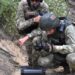 A fighter from Russian Wagner mercenary group and a Belarusian service member take part in a joint training at the Brest military range outside Brest, Belarus, in this still image released July 20, 2023. Belarusian Defence Ministry/Handout via REUTERS ATTENTION EDITORS - THIS IMAGE WAS PROVIDED BY A THIRD PARTY. NO RESALES. NO ARCHIVES. MANDATORY CREDIT.