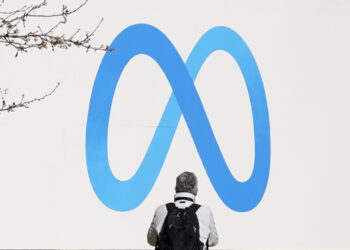 FILE - A person stands in front of a Meta sign outside of the company's headquarters in Menlo Park, Calif., March 7, 2023. Meta releases results on Thursday, Feb. 1, 2024. (AP Photo/Jeff Chiu, File)