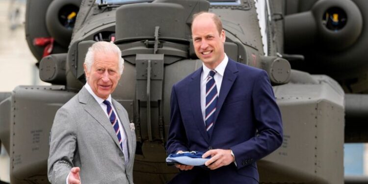 Britain's King Charles III officially hands over the role of Colonel-in-Chief of the Army Air Corps to Britain's Prince William, Prince of Wales in front of an Apache helicopter at the Army Aviation Centre in Middle Wallop, England, on May 13, 2024. (Photo by Kin Cheung / POOL / AFP)