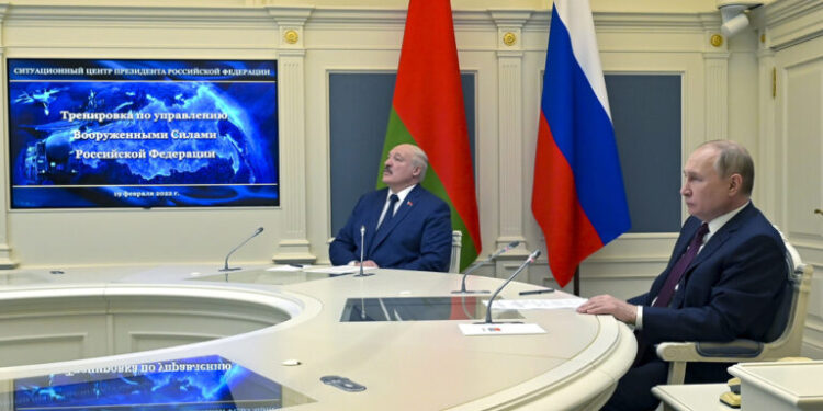 FILE Russian President Vladimir Putin, right, and Belarusian President Alexander Lukashenko watch military drills via videoconference in Moscow, Russia, Saturday, Feb. 19, 2022. The Russian military on Friday announced massive drills of its strategic nuclear forces. Last year, Russia moved some of its tactical nuclear weapons into the territory of its ally Belarus that neighbors Ukraine and NATO members Poland, Latvia and Lithuania. (Alexei Nikolsky, Sputnik, Kremlin Pool Photo via AP, File)