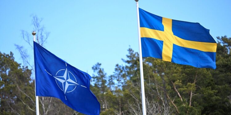 The NATO flag is raised at a ceremony at the Musko navy base near Stockholm, Sweden, March 11, 2024. TT News Agency/Fredrik Sandberg/via REUTERS      ATTENTION EDITORS - THIS IMAGE WAS PROVIDED BY A THIRD PARTY. SWEDEN OUT. NO COMMERCIAL OR EDITORIAL SALES IN SWEDEN.