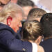 Republican presidential candidate former President Donald Trump is surround by U.S. Secret Service agents as he is helped off the stage at a campaign rally in Butler, Pa., Saturday, July 13, 2024. (AP Photo/Gene J. Puskar)