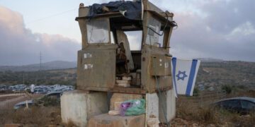 An Israeli soldiers prays in the Eviatar outpost in the Israeli-occupied West Bank during morning prayers calling for the legalization of the outpost and the return of the hostages held in the Gaza Strip by the Hamas militant group, Sunday, July 7, 2024. Far-right ministers in Israel’s government have said they want to legalize unauthorized outposts in the West Bank in a sweeping expansion of settlements. (AP Photo/Ohad Zwigenberg)