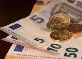 Euro banknotes and coins on the table