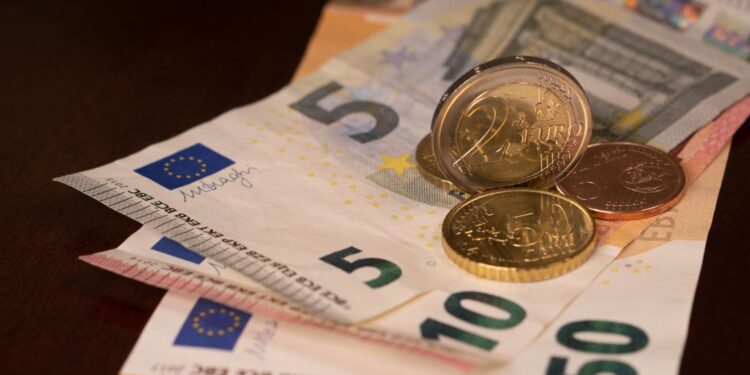 Euro banknotes and coins on the table