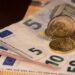 Euro banknotes and coins on the table