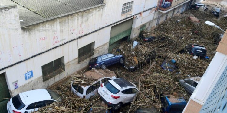 A picture taken in Picanya, near Valencia, eastern Spain, on October 30, 2024 shows cars piled in a stree after floods. Floods triggered by torrential rains in Spain's eastern Valencia region has left 51 people dead, rescue services said on October 30. (Photo by Jose Jordan / AFP)