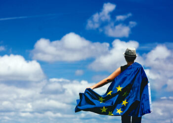 Young woman holding the European Union Flag. Voting concept.