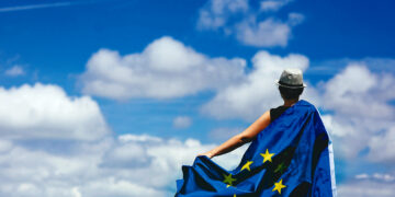 Young woman holding the European Union Flag. Voting concept.