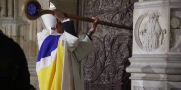 Archbishop of Paris, Bishop Ulrich, knocks on the door of Notre-Dame Cathedral during a ceremony to mark the re-opening of the landmark Cathedral, in central Paris, on December 7, 2024. Around 50 heads of state and government are expected in the French capital to attend the ceremony marking the rebuilding of the Gothic masterpiece five years after the 2019 fire which ravaged the world heritage landmark and toppled its spire. Some 250 companies and hundreds of experts were part of the five-year restoration project at a cost of hundreds of millions of euros. (Photo by Christophe PETIT TESSON / POOL / AFP)