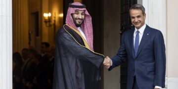 Greek Prime Minister Kyriakos Mitsotakis, right, shakes hands with Saudi Crown Prince Mohammed bin Salman during a welcoming ceremony, in Athens, Tuesday, July 26, 2022. Crown Prince Mohammed bin Salman is visiting Greece Tuesday on his first trip to a European Union country since the killing in 2018 of Saudi journalist Jamal Khashoggi. (AP Photo/Yorgos Karahalis, Pool)