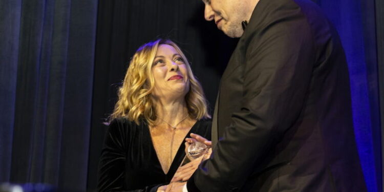 Elon Musk, CEO of Tesla, right, presents Giorgia Meloni, Italy's president of the Council of Ministers, with an award during the Global Citizen Awards dinner, Monday, Sept. 23, 2024, in New York. (AP Photo/Michelle Farsi)