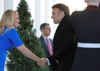 French President Emmanuel Macron is greeted by White House Chief of Protocol Monica Crowley as he arrives at the White House to participate in a G7 leader summit call in Washington, DC, U.S., February 24, 2025.   REUTERS/Brian Snyder