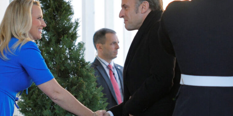 French President Emmanuel Macron is greeted by White House Chief of Protocol Monica Crowley as he arrives at the White House to participate in a G7 leader summit call in Washington, DC, U.S., February 24, 2025.   REUTERS/Brian Snyder