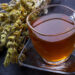 Mountain tea. Sideritis herbal tea and flowers on black slate stone selective focus