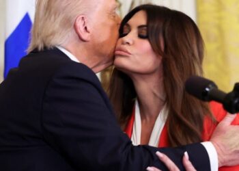 U.S. President Donald Trump kisses Kimberly Guilfoyle, during the Greek Independence Day celebration at the White House in Washington, D.C.,  March 24, 2025.    REUTERS/Kevin Lamarque