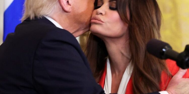 U.S. President Donald Trump kisses Kimberly Guilfoyle, during the Greek Independence Day celebration at the White House in Washington, D.C.,  March 24, 2025.    REUTERS/Kevin Lamarque