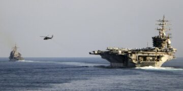 The aircraft carrier USS Dwight D. Eisenhower and other warships crosses the Strait of Hormuz into the Persian Gulf on Sunday, Nov. 26, 2023, as part of a wider American deployment in the Middle East amid the Israel-Hamas war. The Eisenhower was accompanied by the guided-missile cruiser USS Philippine Sea, the guided-missile destroyers USS Gravely and the USS Stethem and the French frigate Languedoc. (Information Technician Second Class Ruskin Naval/U.S. Navy via AP)