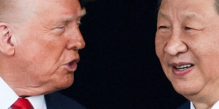 FILE PHOTO: U.S. President Donald Trump and Chinese President Xi Jinping talk as they leave after a bilateral meeting at Gimhae International Airport, on the sidelines of the Asia-Pacific Economic Cooperation (APEC) summit, in Busan, South Korea, October 30, 2025. REUTERS/Evelyn Hockstein/File Photo