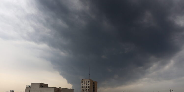 epa12803023 Smoke rises from Tehran’s oil refinery following last night airstrike in Tehran, Iran, 08 March 2026. A joint Israeli and US military operation continues to target multiple locations across Iran since the early hours of 28 February 2026.  EPA/ABEDIN TAHERKENAREH